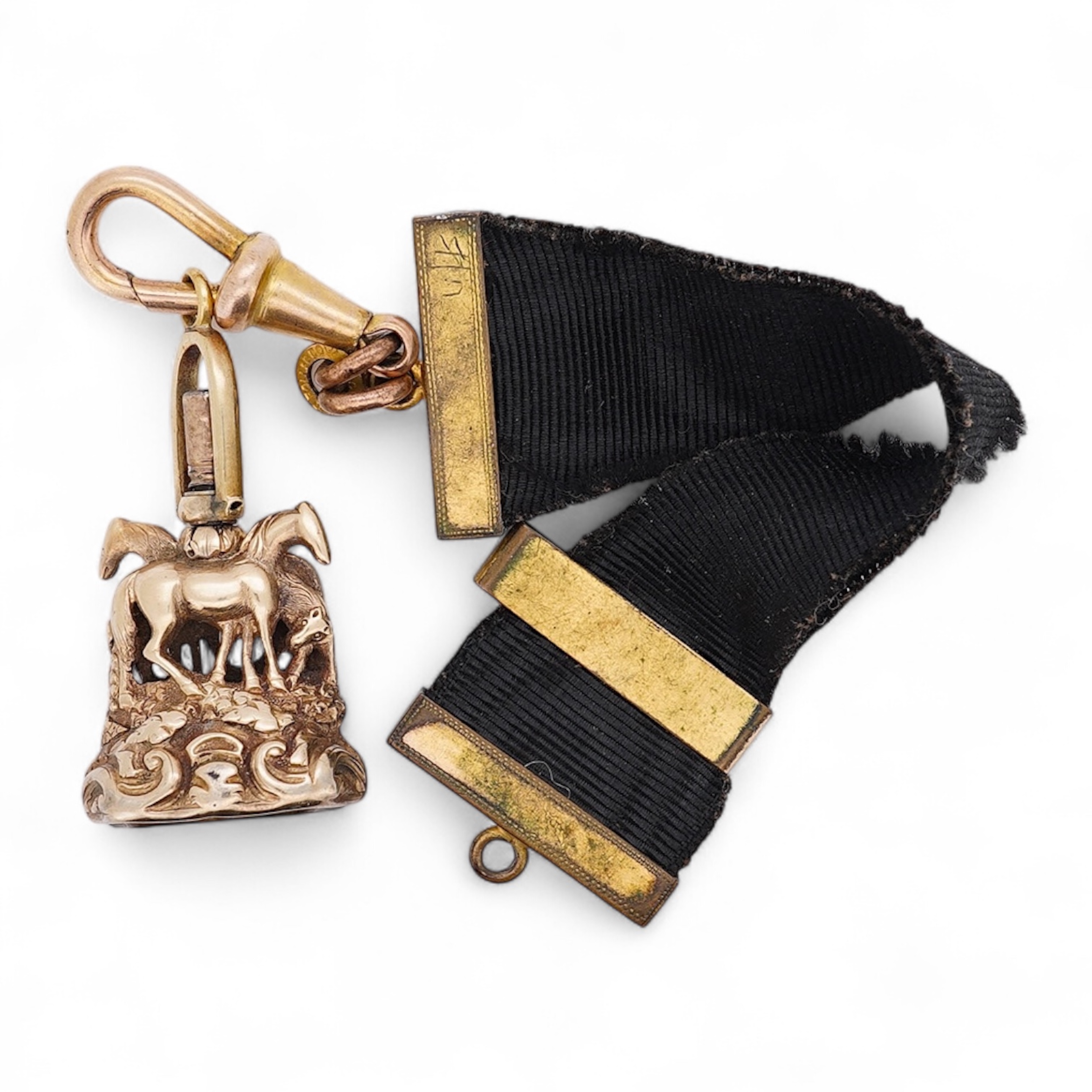 A late Victorian yellow metal overlaid and citrine set watch key fob, depicting two horses and two rams?, 30mm on a black sash suspension, together with a modern pair of 9ct gold and cultured pearl set leaf ear studs. Co